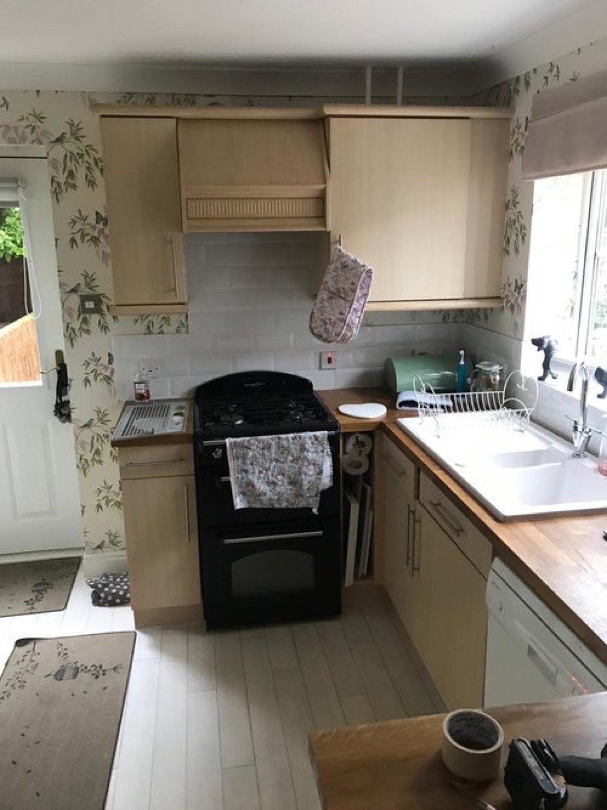 Beech-effect kitchen units and canopy before a ColourHaus makeover