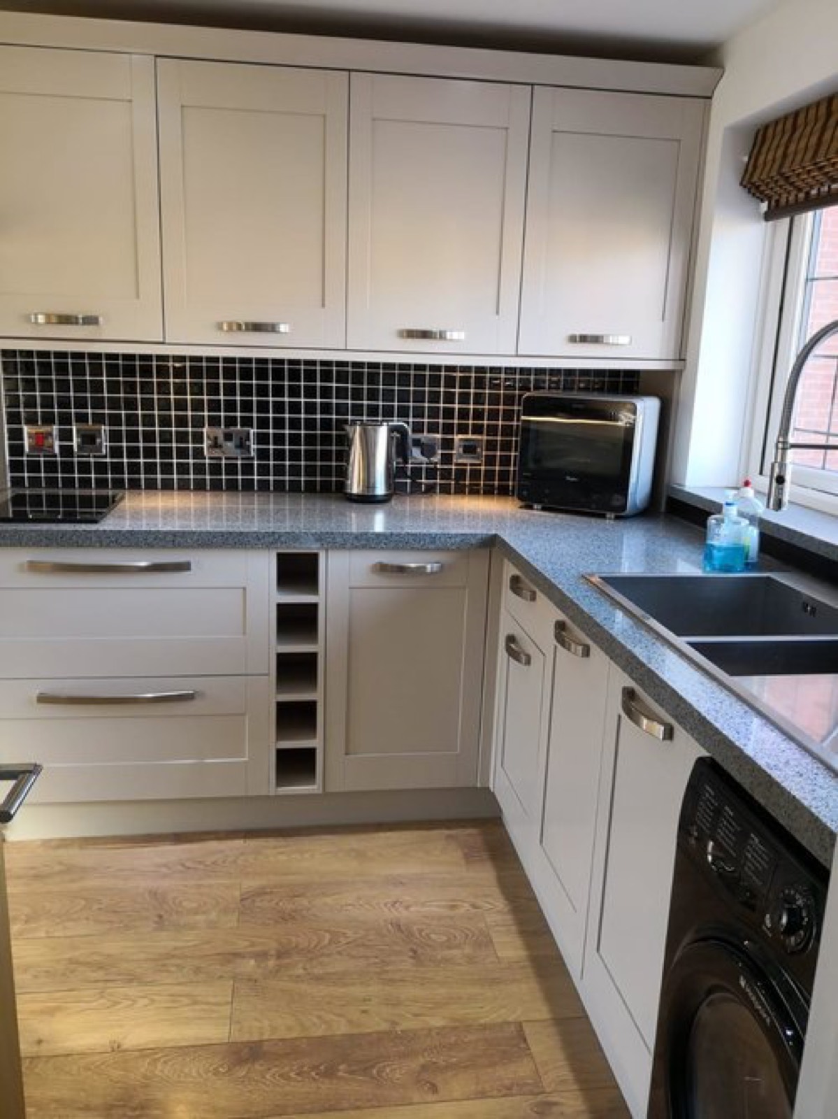 The same Shaker kitchen after respraying in a light stone grey